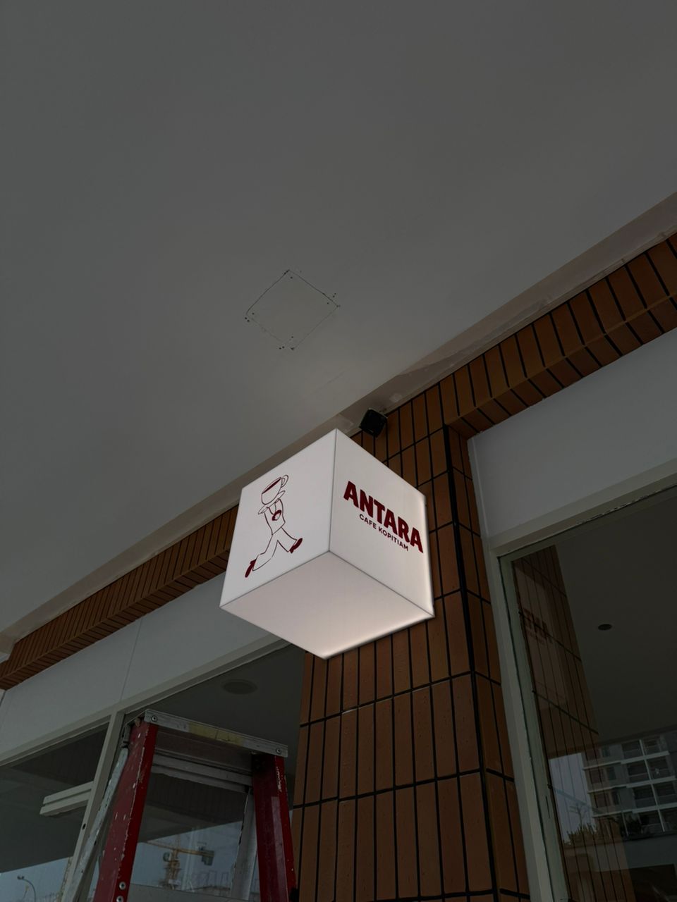 Antara Cafe square acrylic cube lightbox suspended at shopfront entrance Setia Tropika