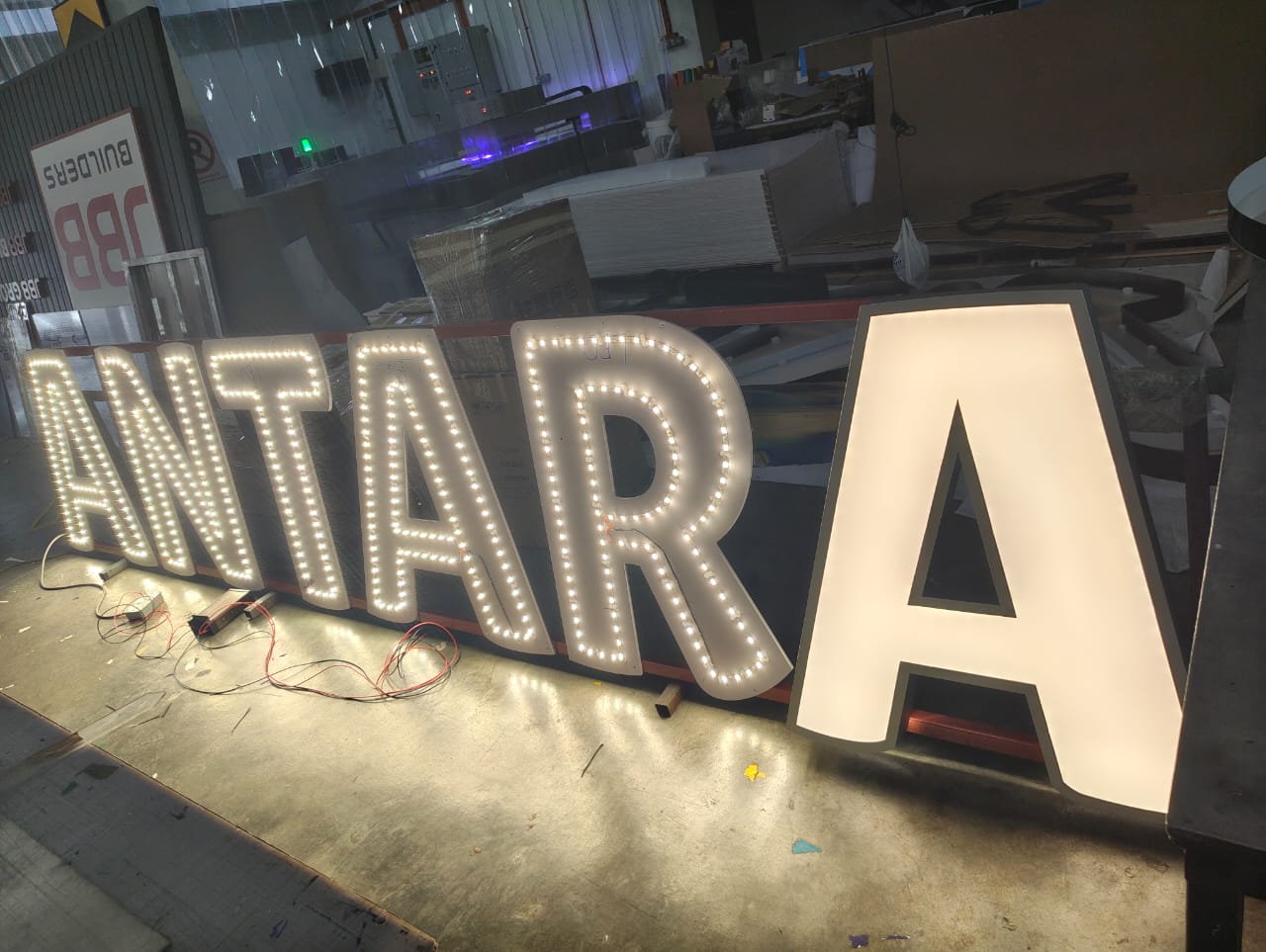 ANTARA frontlit letters with LED bulb lighting test in factory