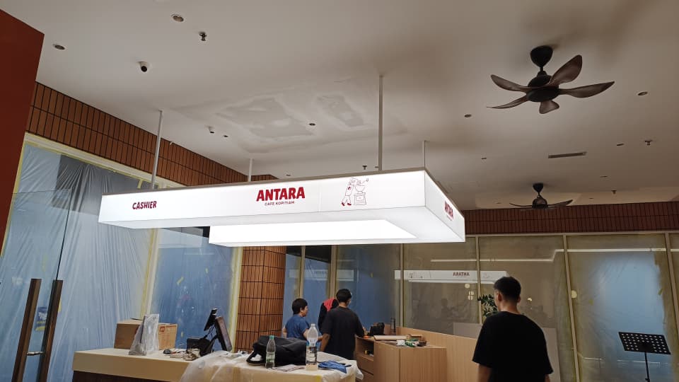 Antara Cafe U-shape acrylic lightbox suspended above cashier counter interior JB
